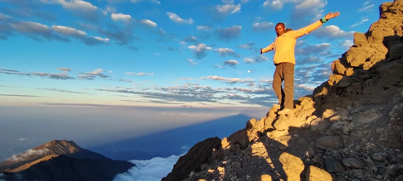 Sunrise on Mount Meru with Kilimanjaro on the horizon